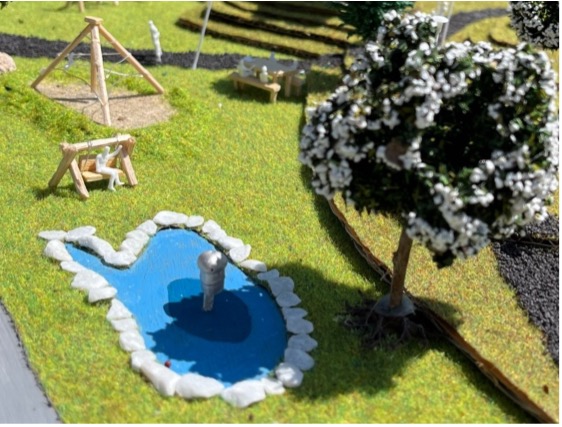 De plaats voorzien voor water en een waterpaddestoel als speelelement vanop de maquette